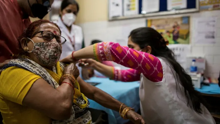 A woman in India gets a coronavirus vaccine jab