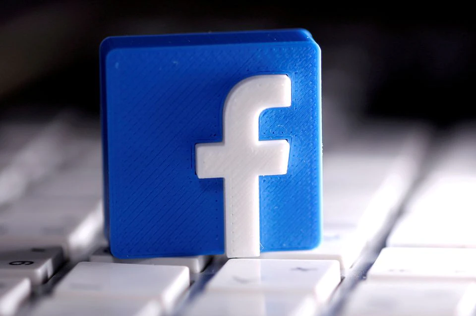 A 3D-printed Facebook logo is seen placed on a keyboard in this illustration taken March 25, 2020. REUTERS/Dado Ruvic/Illustration