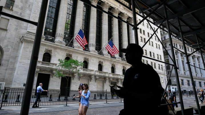 People walk past the New York Stock Exchange (NYSE) on Wall Street on July 12, 2022 in New York City.