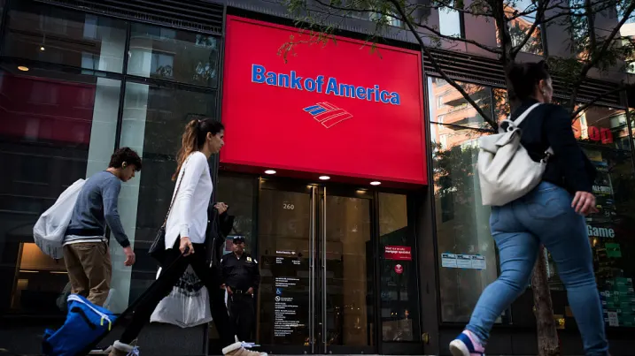 Pedestrians pass in front of a Bank of America branch in New York.
