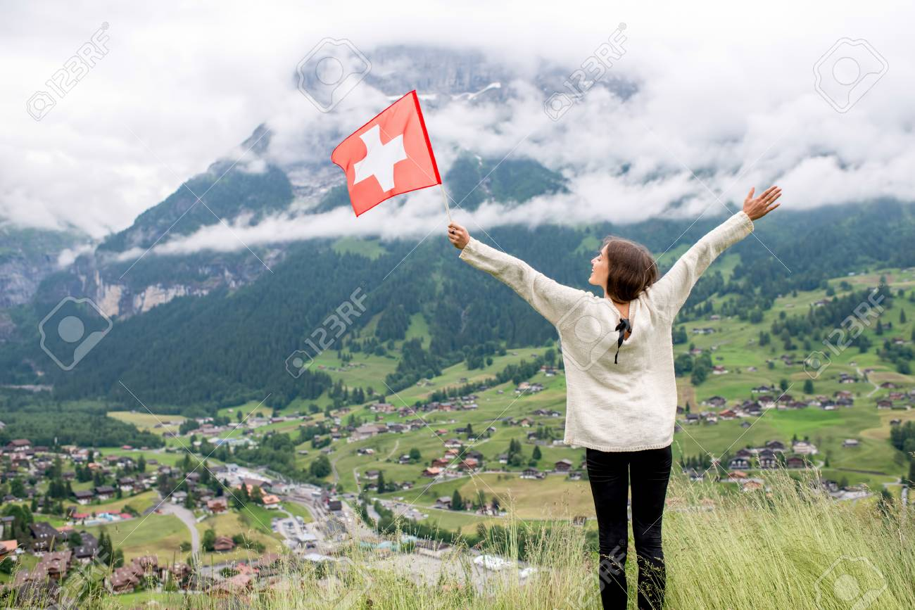 Young Woman With Swiss Flag Enjoying Great View On The Mountains. Having  Happy Vacations In Switzerland Stock Photo, Picture and Royalty Free Image.  Image 66040782.