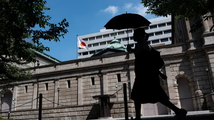 A pedestrian walks past the Bank of Japan (BoJ) building in central Tokyo on July 28, 2023.